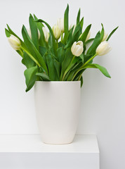 Fresh tulips on a white shelf home decoration
