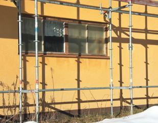scaffolding at a yellow industrial building