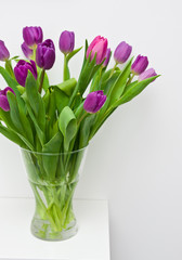 Fresh tulips on a white shelf home decoration
