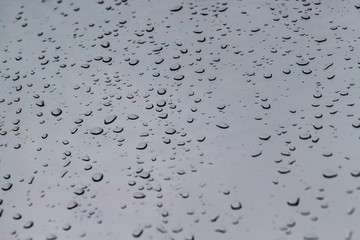 Abstract background with raindrops on the window in gray tone