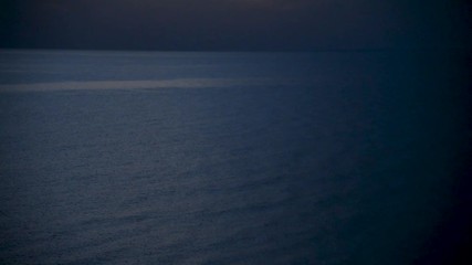 Dramatic stormy sea at twilight. Waves and reflections of last daylight.