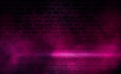 Empty scene background. Empty brick wall, concrete floor, spotlight, multicolored neon rays, bokeh.