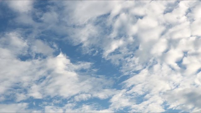 4k white cloudes moving slowly across blue sky