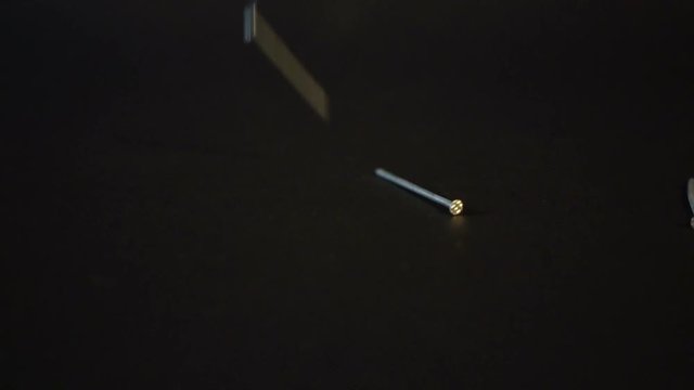 Nails falling on black background Sony a6300 100fps