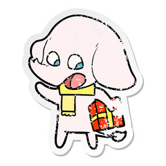 distressed sticker of a cute cartoon elephant with christmas present