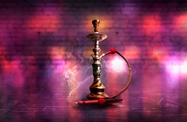 Obraz premium Hookah with smoke on the background of an empty brick wall, wet asphalt and colored neon light, blurry lights of the night city, bokeh