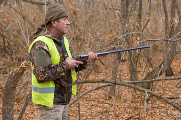 Fototapeta premium Hunters with a german drathaar and spaniel, pigeon hunting with dogs in reflective vests 