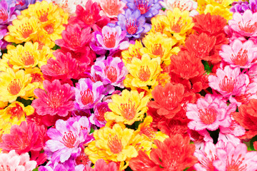 a bouquet of a mixture of different colors of artificial carnations, for decoration