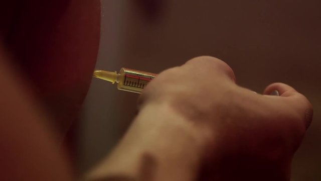 Steriod nutrition injection liquid medicine being infused on the arms by a nervous bodybuilder