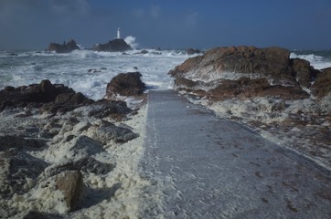 La Corbiere, Jersey, U.K. Coastal lighthouse with stormy weather.