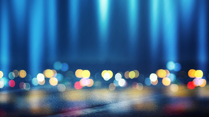 Dark empty stage, multicolored rays of neon searchlight, wet asphalt, smoke, night shooting, bokeh...