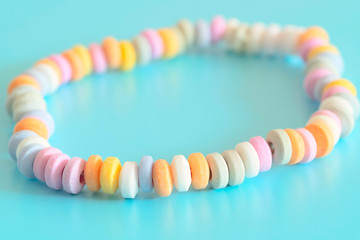 Beads and bracelets of sweets  candy on a turquoise background