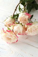 White roses on a wooden background