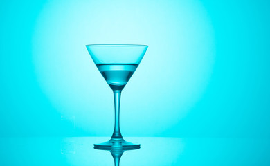 Martini glass on color background