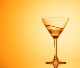 Martini glass on color background