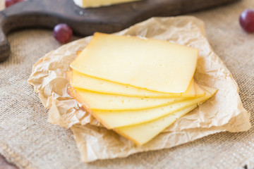 Close up of sliced cheese on rustic background