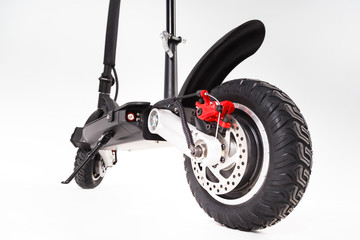 Focus on the rear wheel of a scooter with disc brakes
