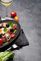 Greek salad plate and white wine