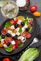 Greek salad plate and white wine