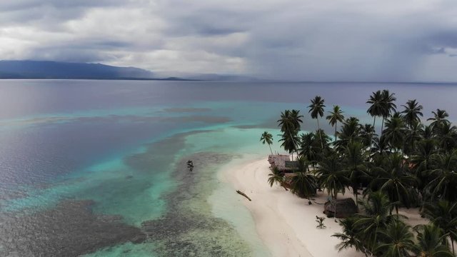 Aerial drone view beach huts on tropical island with palm trees in san blas islands panama also known as guna yala