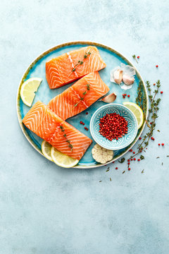Seafood. Fresh raw salmon or trout fillets with ingredients, top view, space for a text