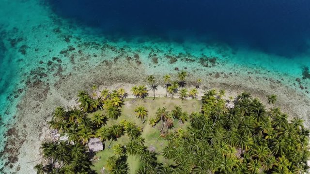 beach hut on remote palm tree covered island in San Blas archipelago Guna Yala Panama