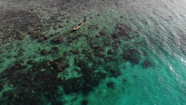 aerial view local Guna poles canoe over reef in San Blas Islands archipelago Panama