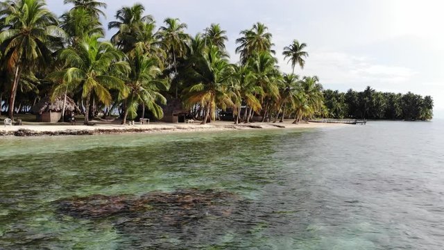 aerial reveal remote tropical island with hut in San Blas archipelago Guna Yala Panama