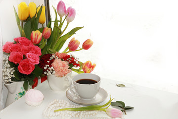 cup of coffee and a bouquet of flowers on a white background, a beautiful morning and the arrival of spring