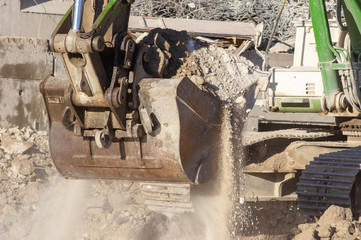 Close-up of a excavator bucket digging ground