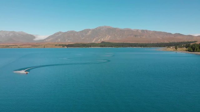 FASTMO - Jet Ski on Beautiful Turquoise Blue Water - Lake Tekapo, New Zealand - Aerial