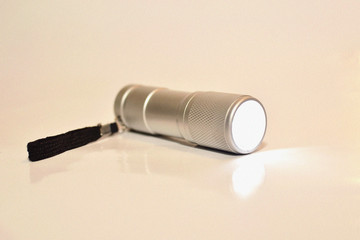 Included flashlight shines on a white background