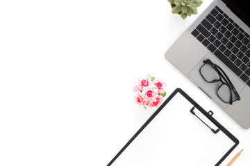 Creative flat lay photo of workspace desk. Top view office desk with laptop, glasses, pencil, blank clipboard and plant on white color background. Top view with copy space, flat lay photography.