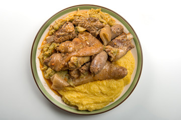 Plate with pork meat and savoy cabbage and polenta