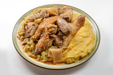 Plate with pork meat and savoy cabbage and polenta