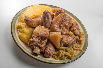 Plate with pork meat and savoy cabbage and polenta