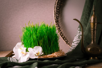 Novruz still life with semeni sabzi wheat grass , silk national scarf, eastern musical instrument and orchids. Spring equinox in March celebration, copy space 