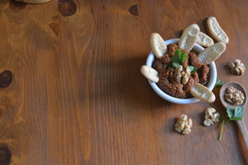 tapas in a white bowl on a wooden texture background