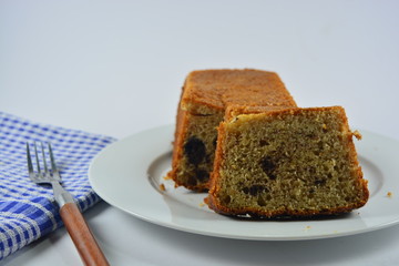 homemade banana cake on a white plate on a white background