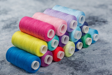 Sewing threads on drums. A lot of colored threads for designers.