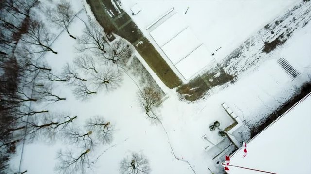 Cinematic drone / aerial footage moving forwards showing the lookout Mont Royal Chalet at Montreal, Quebec, Canada during winter season.