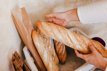 Fresh and warm. close up woman hand holding fresh and warm bread just from the oven. Bakery concept