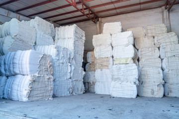 Interior of a storehouse .Stacked waste textile scraps In Bales.