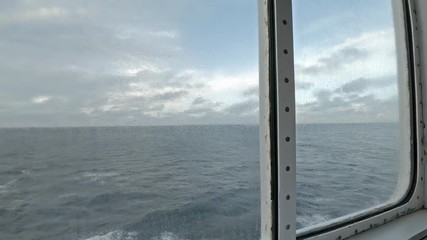 View of sea through the scuttle of the vessel