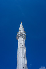 white minaret against the blue sky