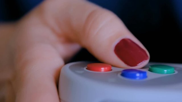 Woman using retro gaming console controller. Gaming, hobby, technology and leisure time concept