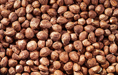 Peeled hazel nuts as background. Organic hazelnuts, top view.