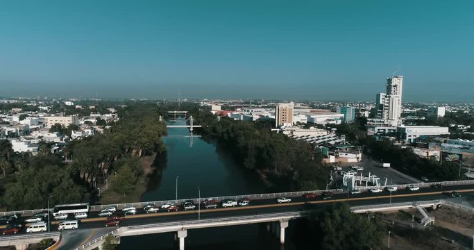 Aerial shot of city traffic in a bridge crossing the Tamazula river in the city of Culiacan Sinaloa