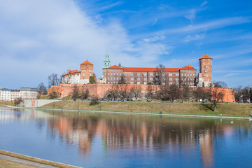 Wawel Royal Castle famous landmark in Krakow Poland. Picturesque landscape on coast river Vistula.  Blue sky and cloud. February 23, 2019.