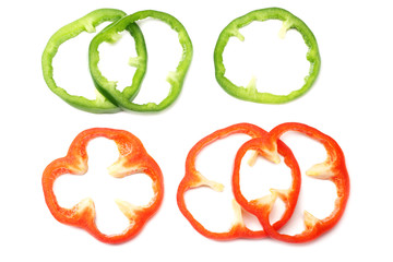 cut slices of red and green sweet bell pepper isolated on white background top view